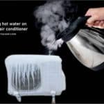 Pouring hot water on frozen air conditioner